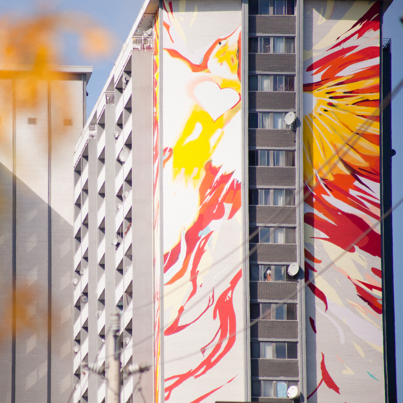 A close up photo shows the 200 Wellesley St. Mural by Sean Martindale
