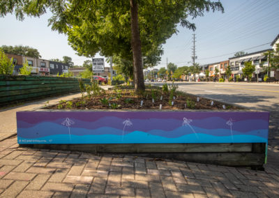 Blue and purple painted planter boxes by MJ Jean-Louise for Clarkson Village BIA's Main Street public art activation