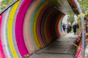 Pedestrian tunnel that is painted in different colour stripes by PA System in Toronto