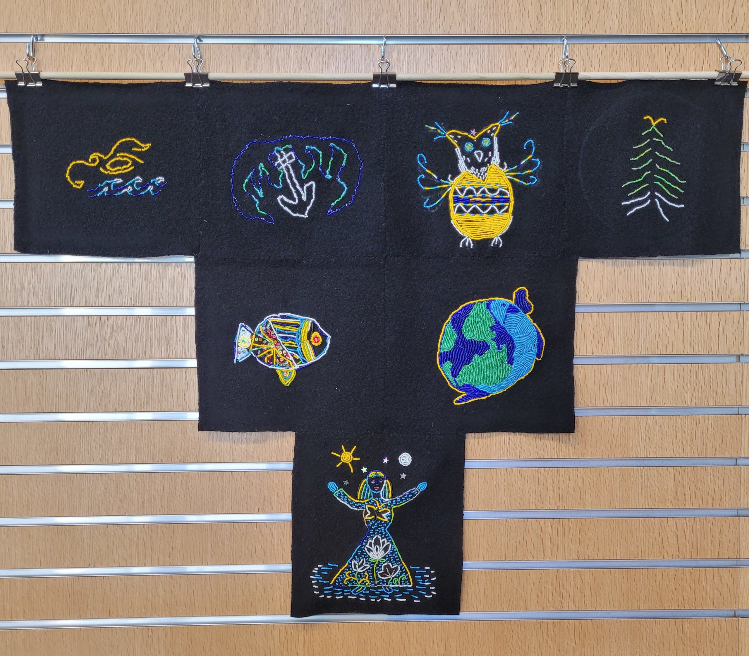 Photo of collective tapestry of beaded artworks at Albion Library.