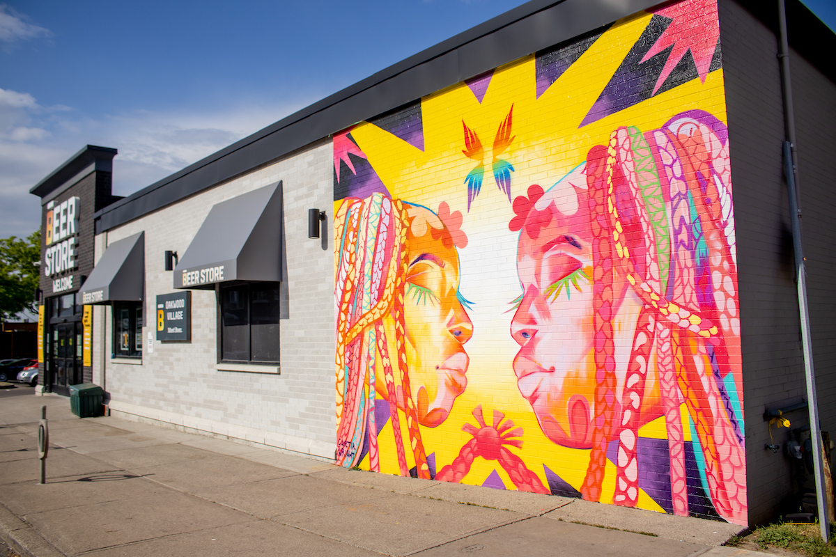 A colorful mural by Curtia Wright in Toronto shows two figures in harmony