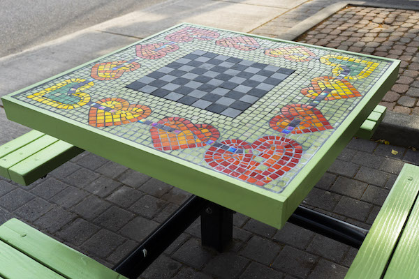 A picnic bench with a mosaic of hearts