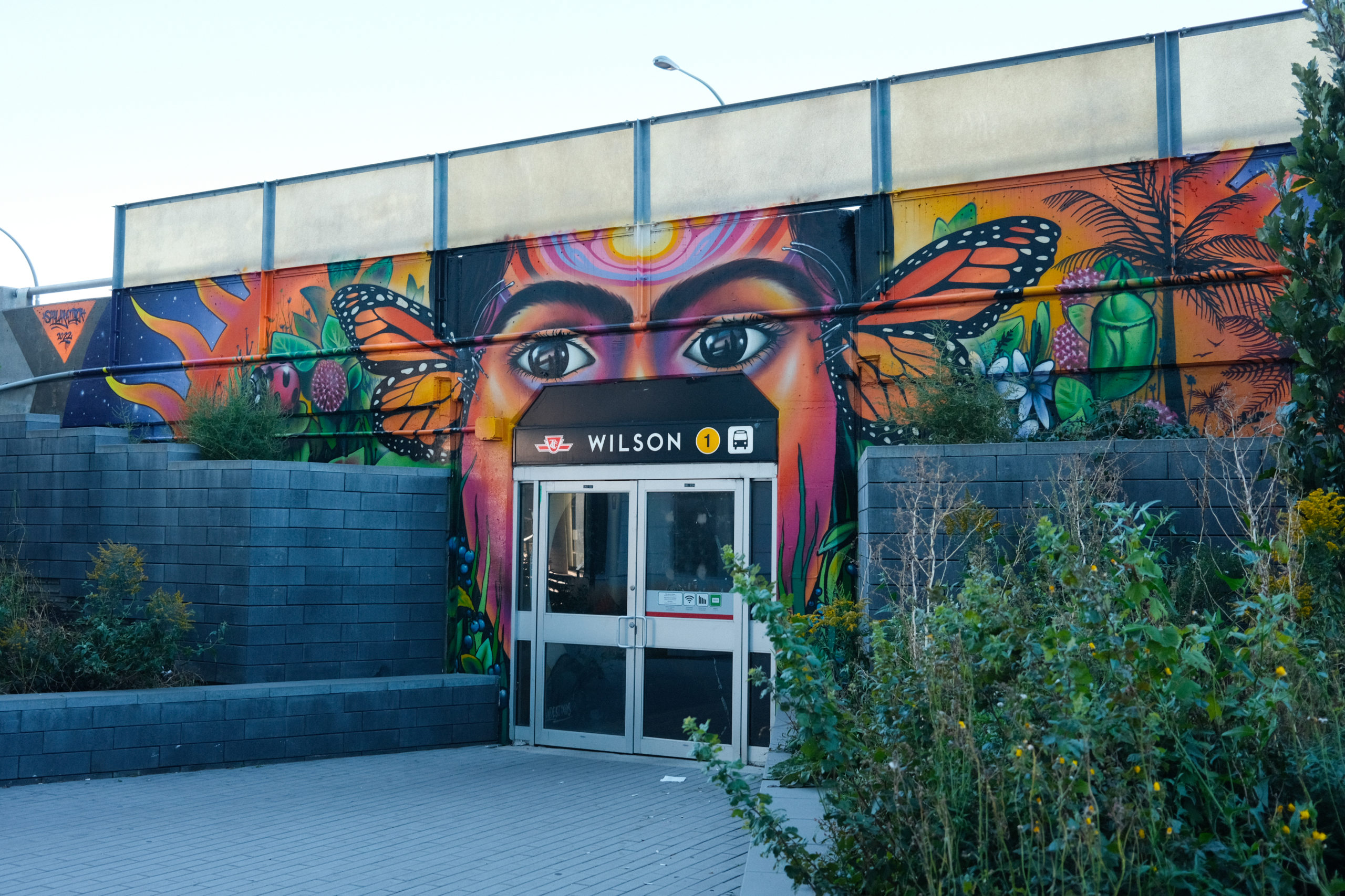 A large mural at the entrance of Wilson TTC subway Station in Toronto by artist Shalak Attack.