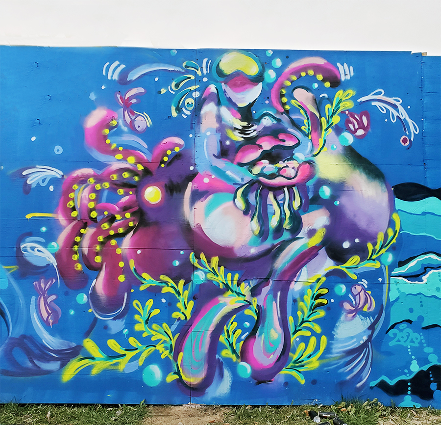 Photograph of a colourful mural by artist Enna Kim featuring an abstract underwater scene painted in shades of purple and pink with highlights of green set against a blue background.