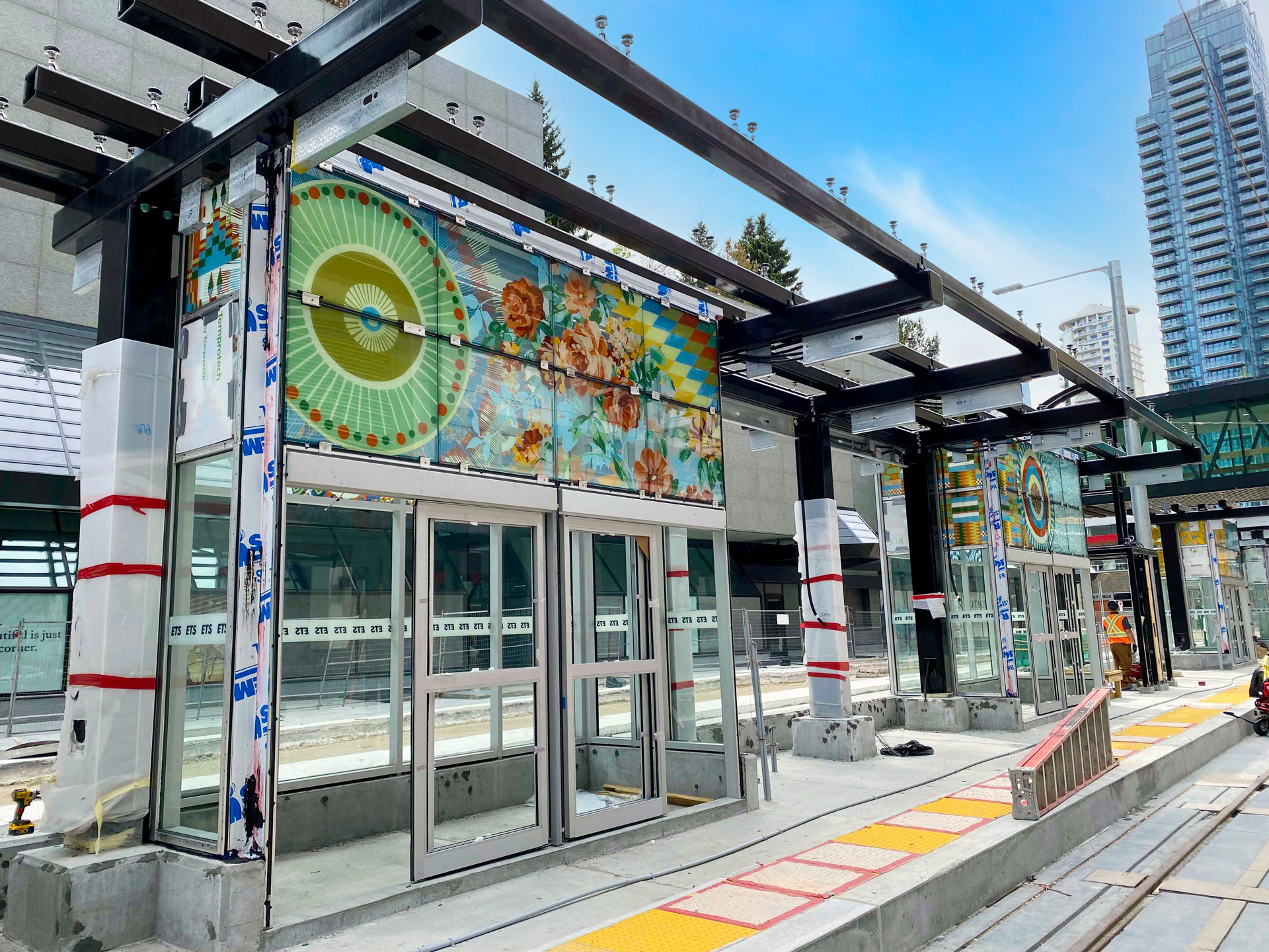 outdoor mural on transit station entryway of colourful abstract pattern