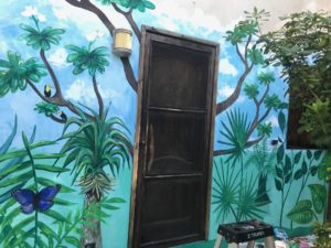 tropical mural surrounding a door
