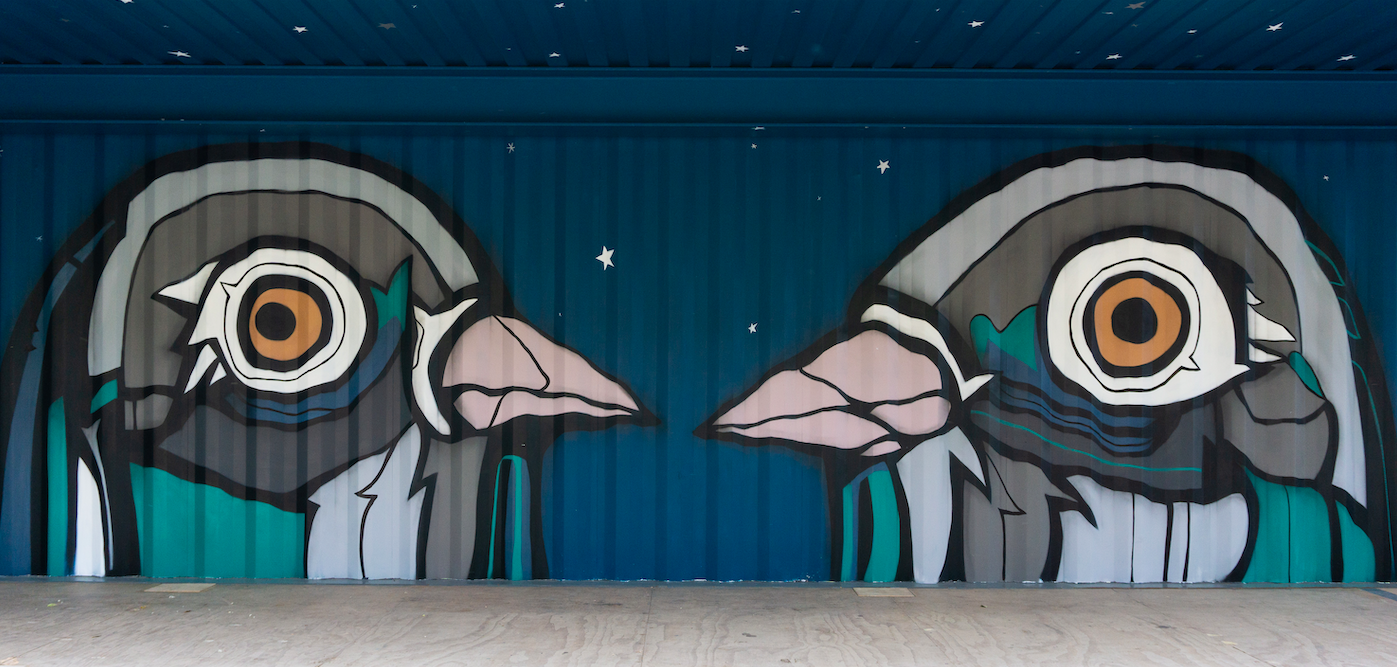Large mural of two pigeons facing each other by Fatspatrol on shipping containers