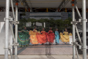 Toronto Makes Good Hoarding Exhibit featuring photograph by Tenzin Dorje of six girls wearing colourful dresses and standing in a row