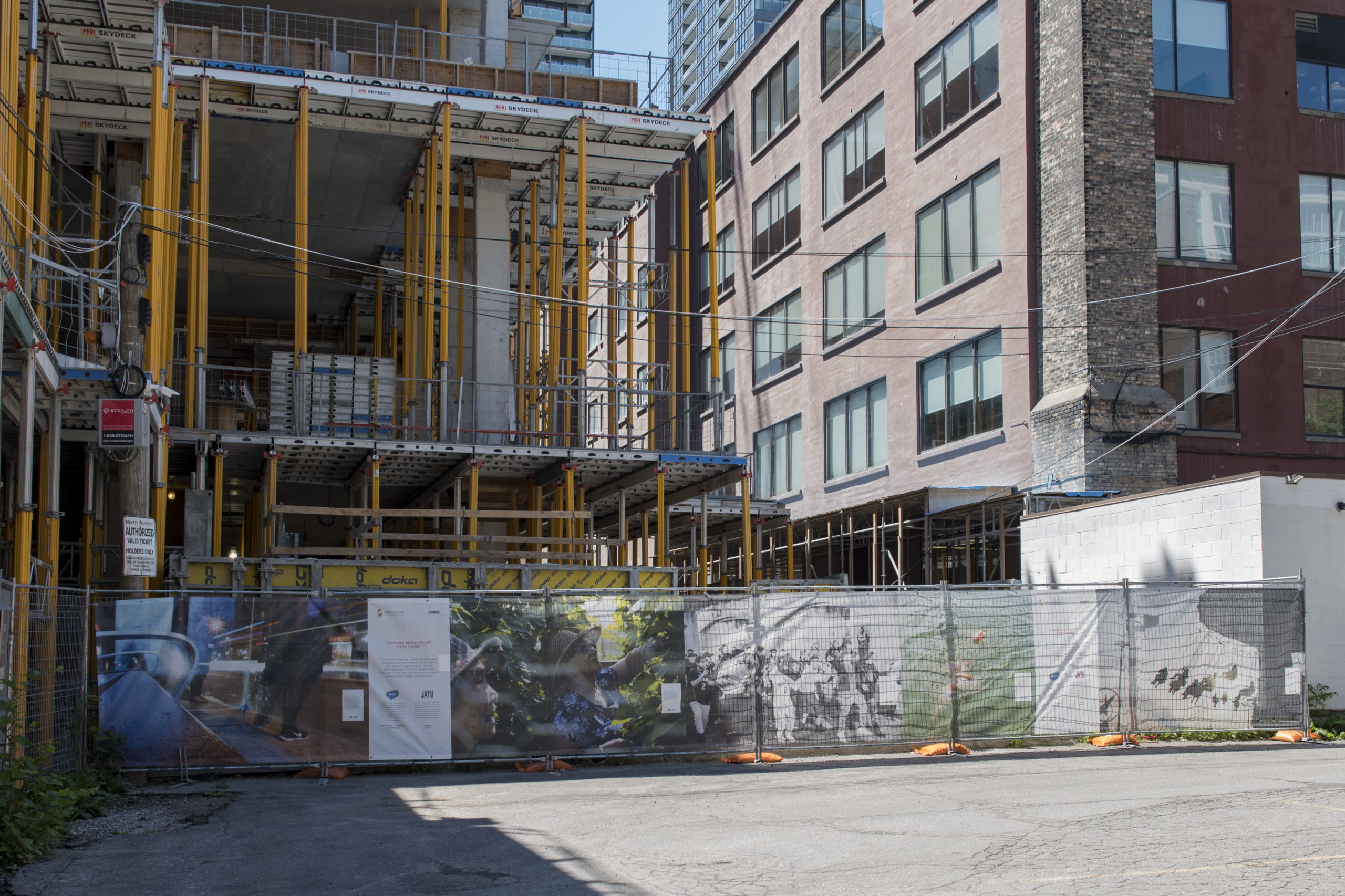 Toronto Makes Good Hoarding Exhibit with photographs on mesh fencing in a construction site