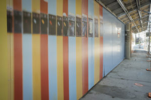 Hoarding exhibit by Laird Kay. The exhibit features large scale photographs, including a photograph of orange, yellow and blue lockers