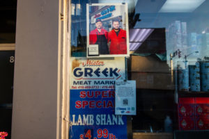 Humans of the Danforth outdoor photo gallery exhibit featuring Bill and Nick of Mr. Greek Meat Market