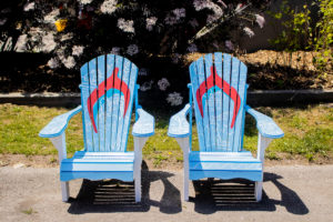 Two blue muskoka chairs that resemble giant flip flops by Steven Twigg