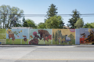 Danielle Cole's hoarding exhibit on a sunny day with illustrations of bears, parks, and nature.