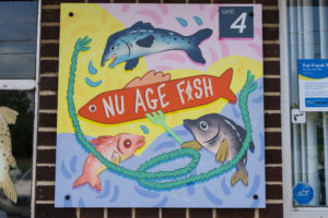 The Nu Age Fish Storefront decorated with a photo-drawing collage by Yen Linh Thai