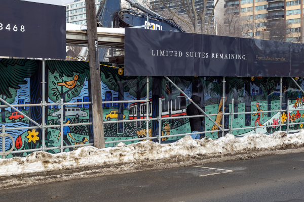 Photograph of a construction hoarding that has a mural printed on it. The artwork features imagery of scenes from a park like green parks, animals, cars and people exercising and walking their dogs. It has a lot of bright colours with the city skyline in the background.