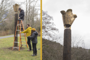 Two photographs merged together, the first one features three people installing an art work surrounded by nature. The second features a close-up view of the artwork, which is a tall pillar with a brass sculpture at the top.