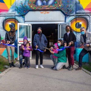 Daily Migration Mural is unveiled at Wilson subway station by a group of people