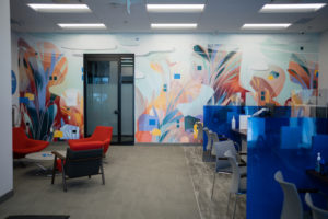 Interior mural with bright teal, orange, and red tones in a BMO office