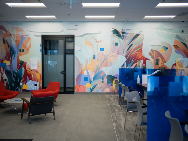 An interior digital vinyl mural in pastel colours and abstract style with silhouettes and wispy layers by artist Mary Haasdyk as part of the BMO National Mural Series by STEPS Public Art