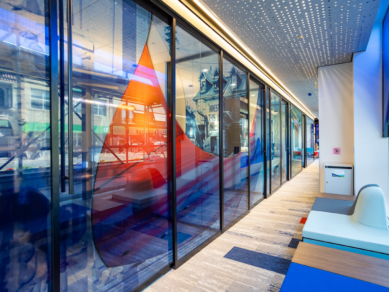 Interior bank offices with photographic artwork in the glass windows as part of the BMO National Mural Series with STEPS Public Art and artist Jessica Thallman