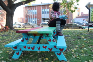Anna Jane McIntyre poses with her public art project bench in Montreal