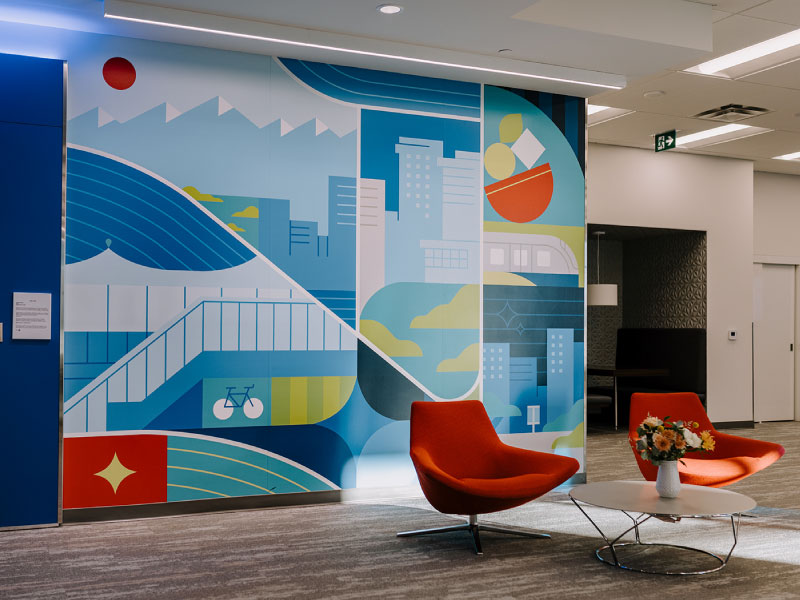 Interior digital vinyl mural of a cityscape and mountain peaks by artist Cynthia Tran Vo as part of the BMO National Mural Series by STEPS Public Art