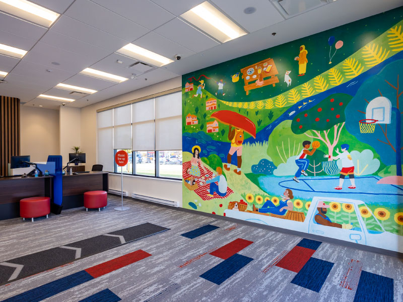 An interior digital vinyl mural by artist Erin McCluskey as part of the BMO National Mural Series by STEPS Public Art. Children are playing in the scene along the Humber River.