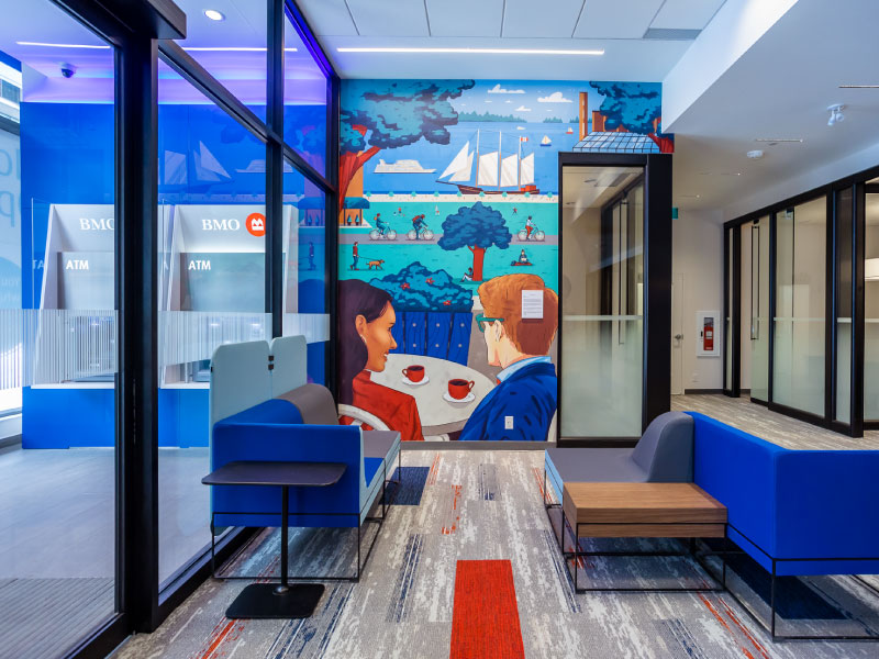 An interior digital vinyl mural by artist Raz Latif as part of the BMO National Mural Series by STEPS Public Art. It depicts two people having coffee over a waterfront view.