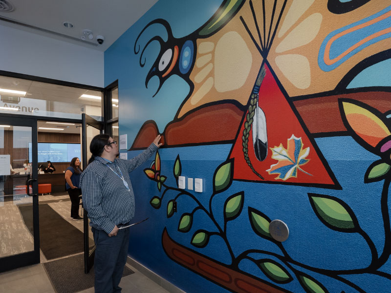 An interior digital vinyl by artist Jordan Quequish of a teepee and thunderbird as part of the BMO National Mural Series by STEPS Public Art