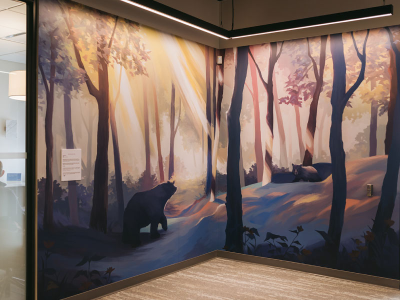 An interior vinyl mural of a forest with bears by artist Marcelline Siu as part of the BMO National Mural Series by STEPS Public Art