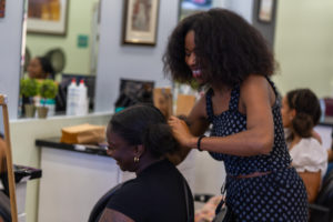 A participant sits and gets their hair done at "The Mane Event" workshop in Torontoi, hosted by D'Andra Montaque of Empress Mane