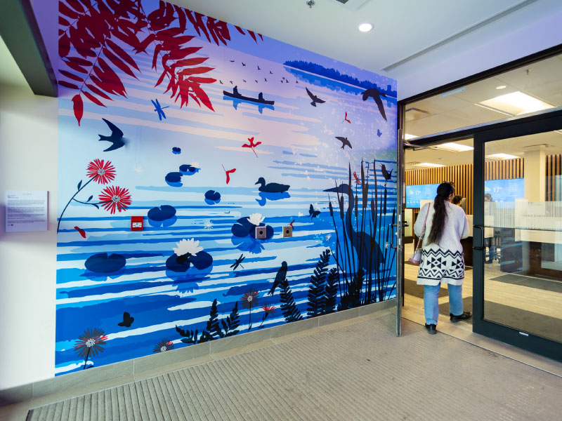 A digital vinyl mural at the entrance of a BMO bank by artist Pam Lostracco as part of STEPS Public Art's BMO National Mural Series