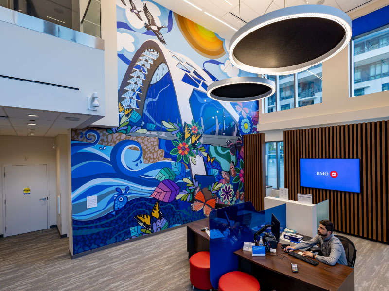 A large floor to ceiling digital vinyl mural by artist Poonam Sharma depicting the Humber Arch Bridge and the water, wildlife, and fauna surrounding it as part of the BMO National Mural Series by STEPS Public Art