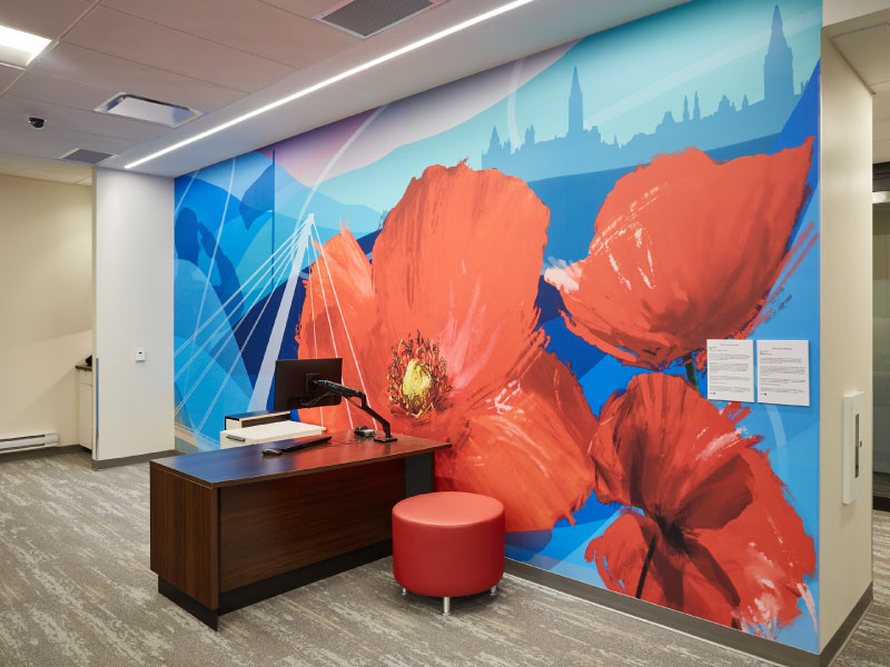 An interior digital vinyl of red poppies on top of a blue layered background by artist Ryan Smeeton as part of the BMO National Mural Series by STEPS Public Art