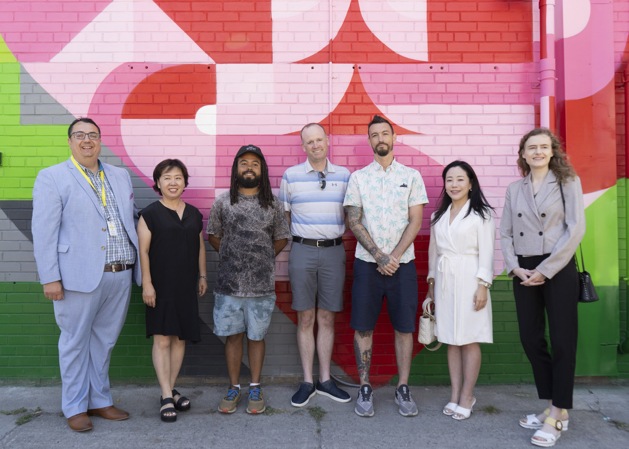 A group photo with artists Leyland Adams and Peru Dyer Jalea, and Willowdale BIA to celebrate a new mural production in Toronto's North York