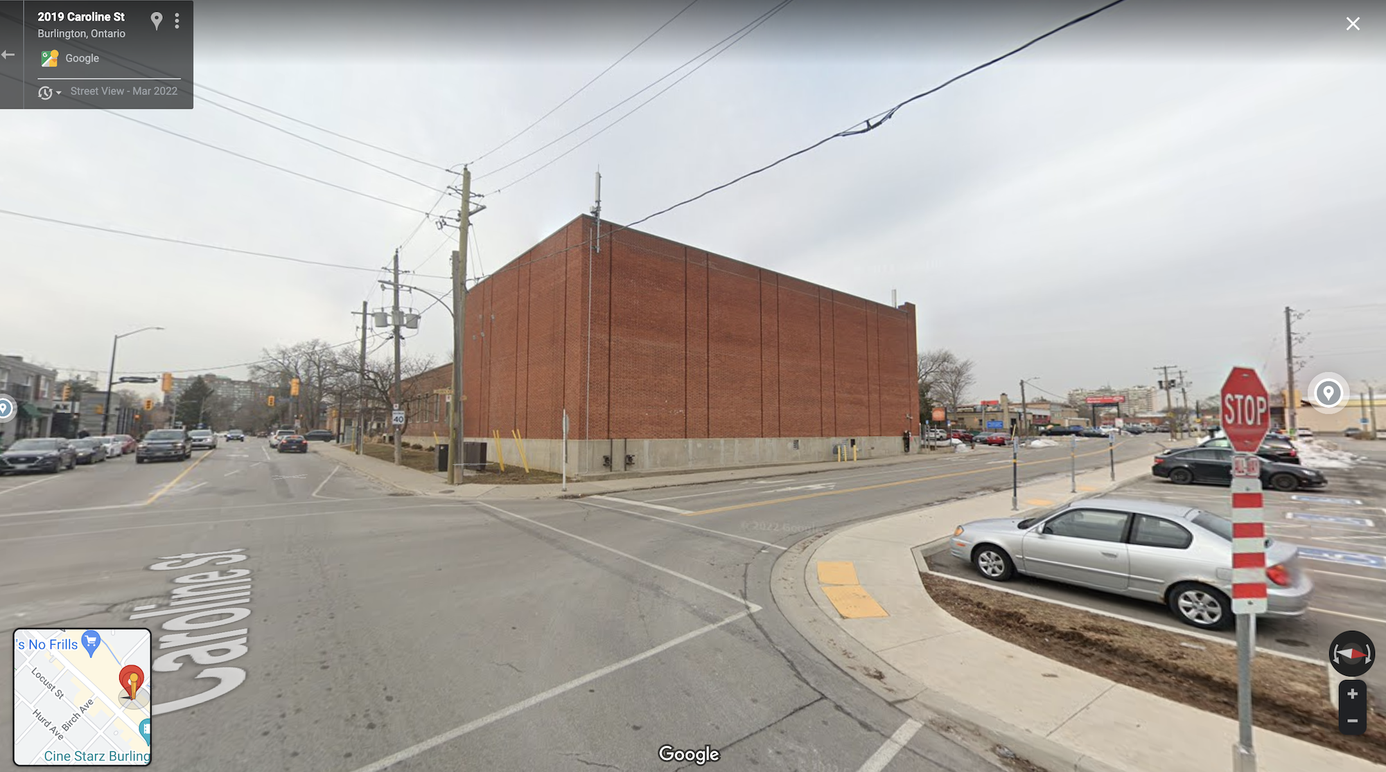 Google street view of a large brick building in Burlington, Ontario at the corner of an stop-sign intersection