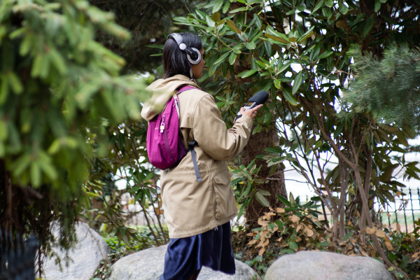 Saroja Ponnambalam wearing audio gear and recording sounds in nature