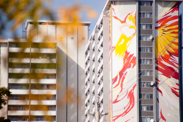 The World's Tallest Mural in Toronto's St Jamestown depicting an orange and yellow phoenix along a 23-storey apartment building