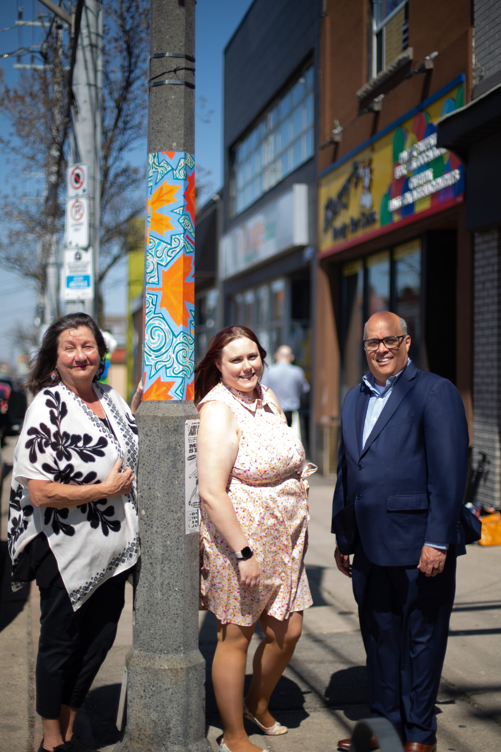 Sharon Trottier and representatives from Ottawa Street BIA and RBC celebrate the series of vinyl lamp post murals along Ottawa St N