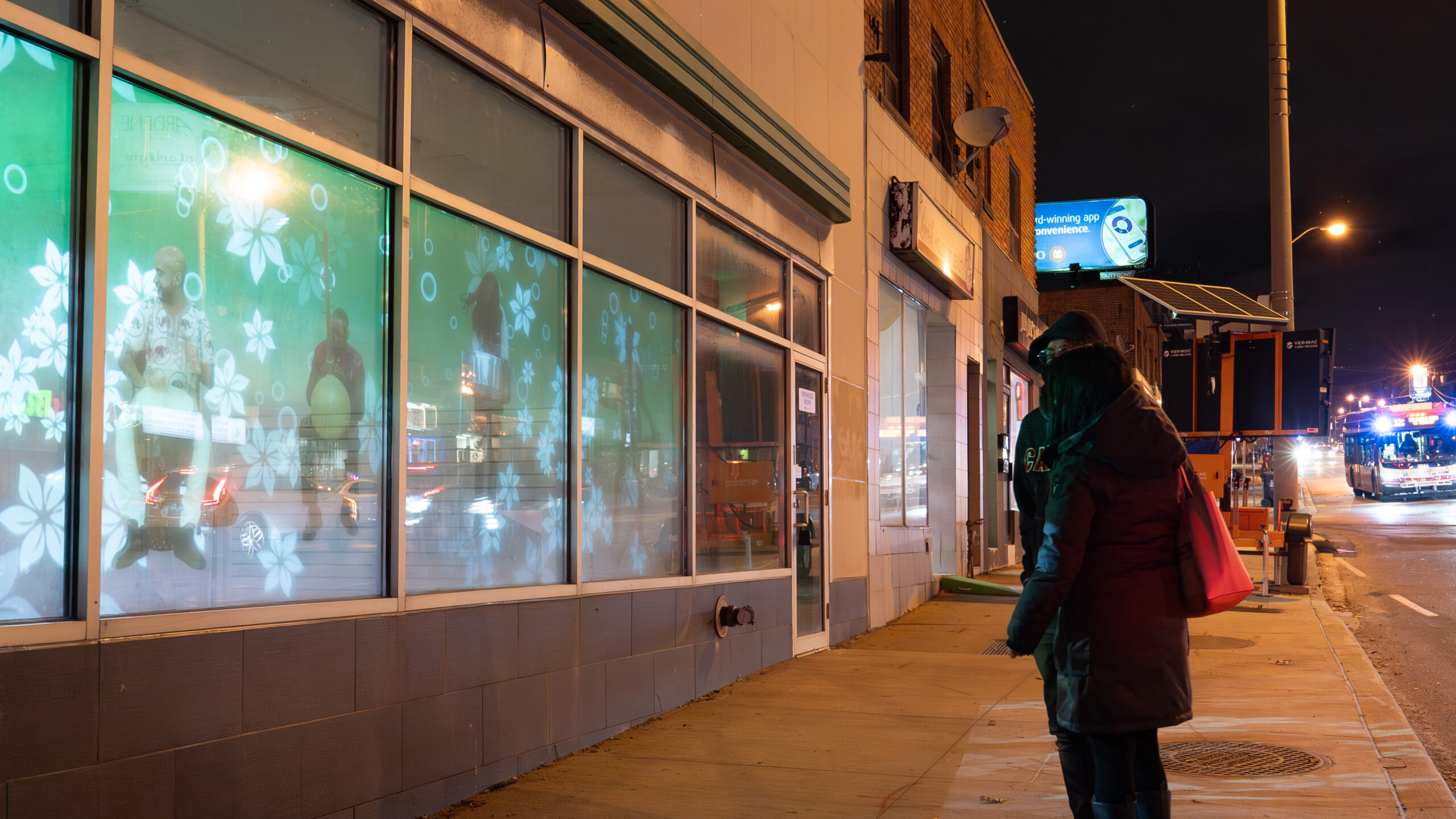 The Magic Windows installation lights up storefront windows in Toronto's Little Jamaica
