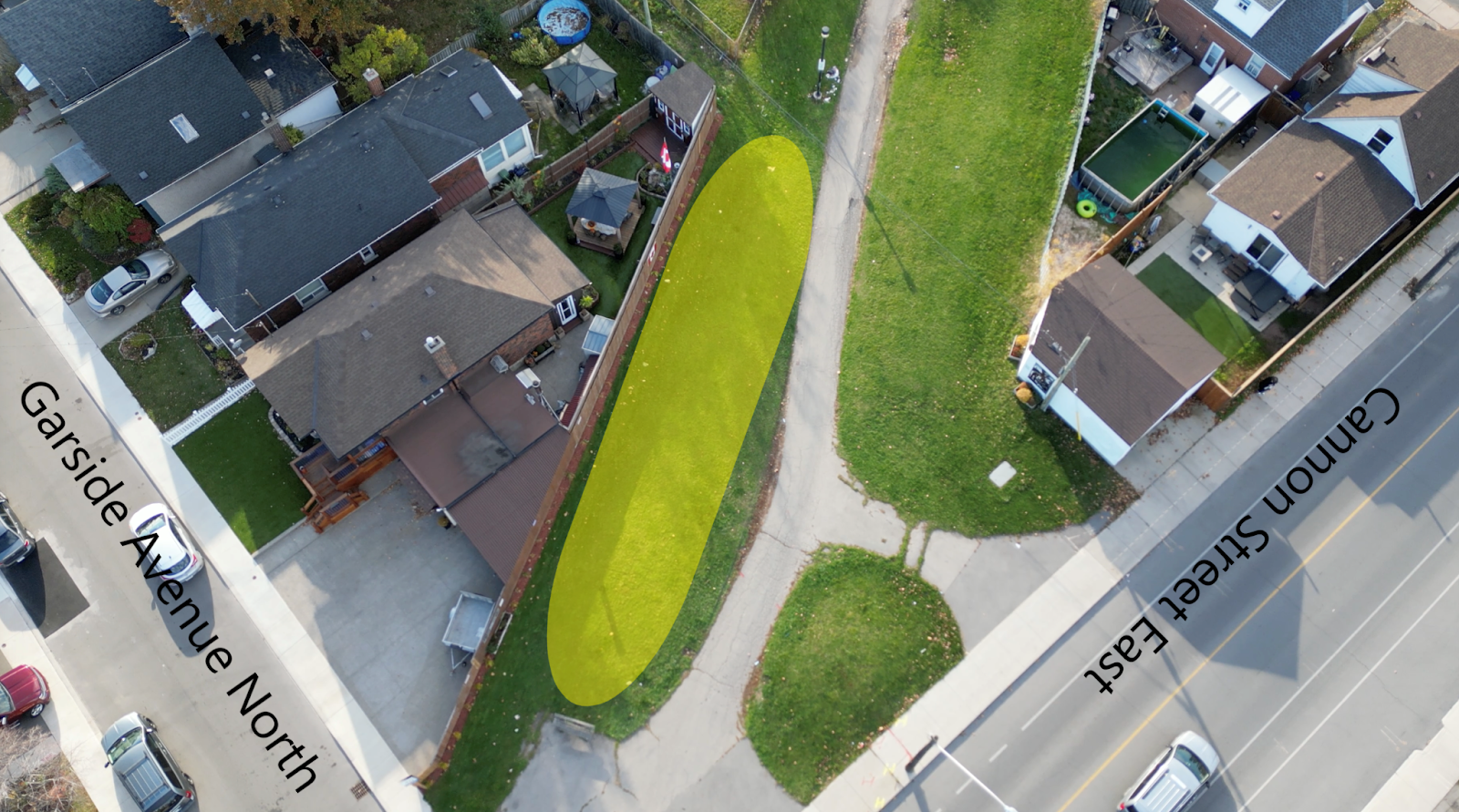 Aerial view of the City of Hamilton pipeline trail with a circle around where the new public artwork will be installed. there are instructional text outlining the intersection (Garside Avenue North and Cannon Street East)