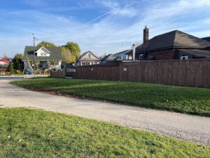 Eastward facing view of the City of Hamilton pipeline trail that is long and grassy with surrounding residential homes