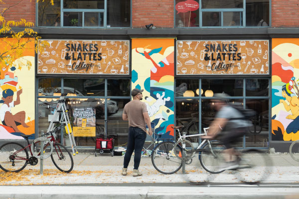 Snakes and Lattes College in Toronto with three painted murals on the exterior of the building my artist Jinke Wang for CATAN and STEPS Public Art
