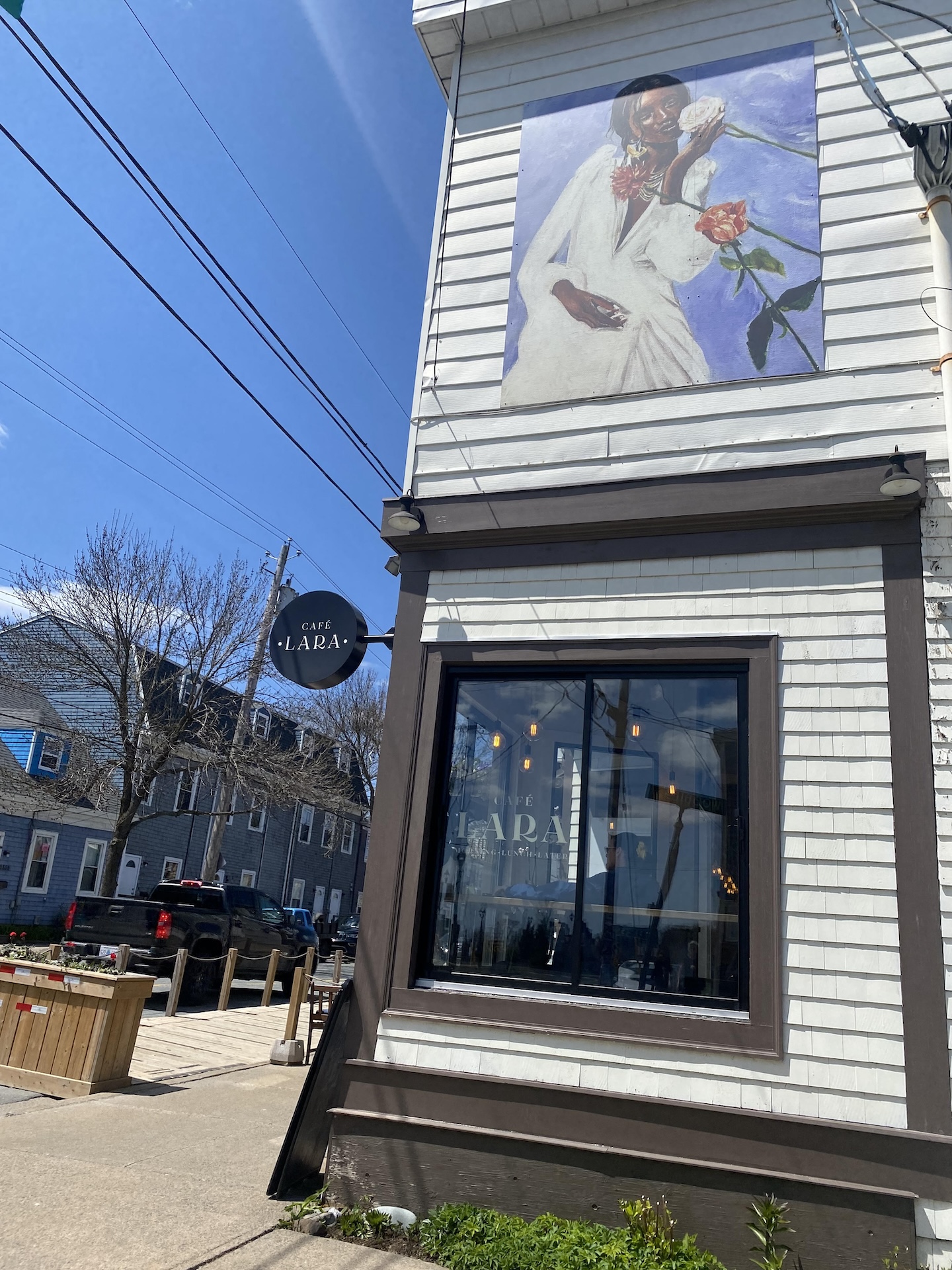 Give Her Flowers, a digitally printed mural on top of Cafe Lara in Halifax by artist Jasmin-Nicole Amoako as part of STEPS Public Art's CreateSpace Public Art Residency