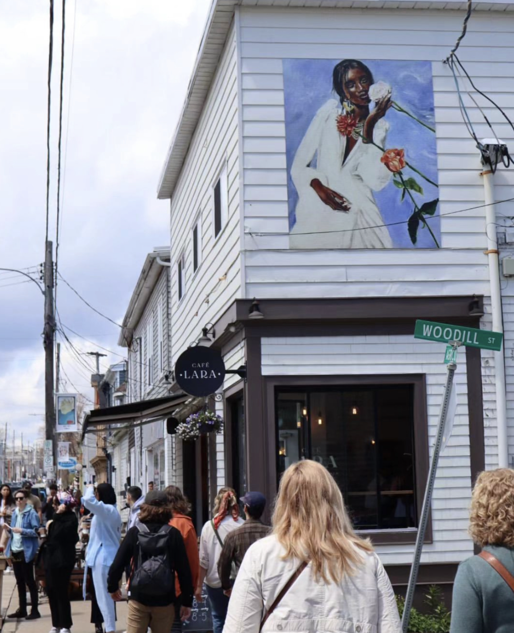Give Her Flowers, a digitally printed mural on top of Cafe Lara in Halifax by artist Jasmin-Nicole Amoako as part of STEPS Public Art's CreateSpace Public Art Residency