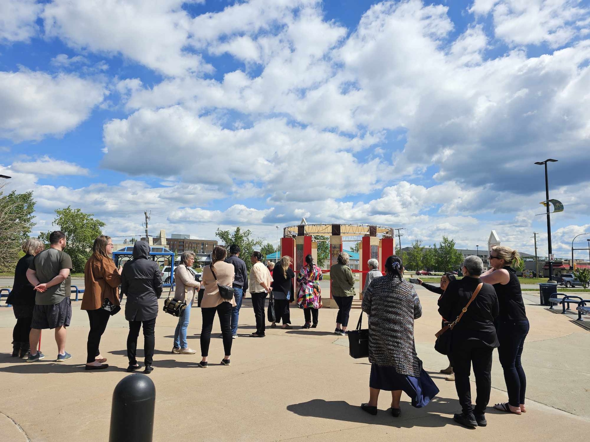 A group of people at a public art installation unveiling in Fort St John by artist Ovvian Castrillo Hill as part of the CreateSpace Public Art Residency by STEPS Public Art