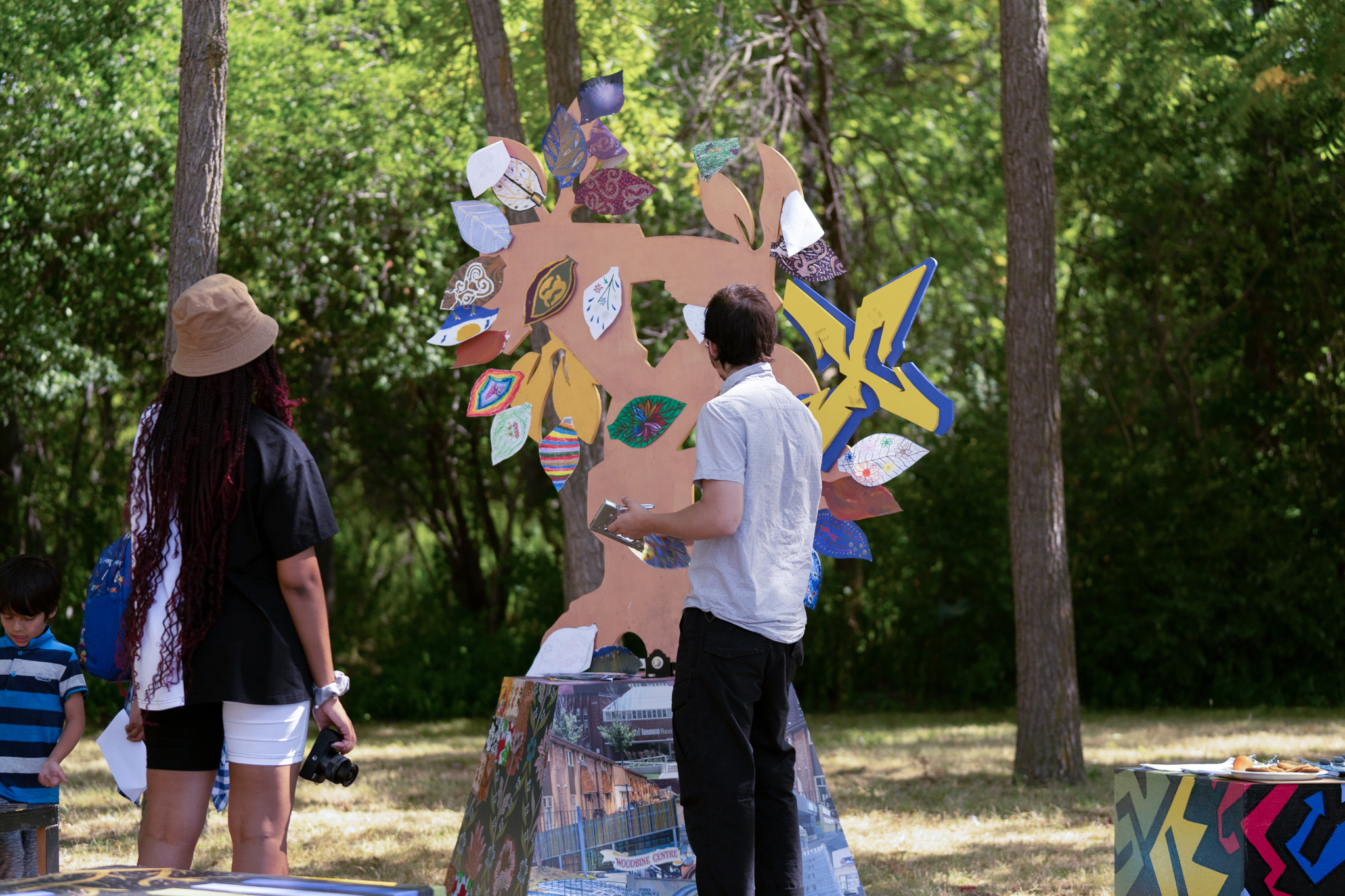 Two people viewing a sculpture in the park. 