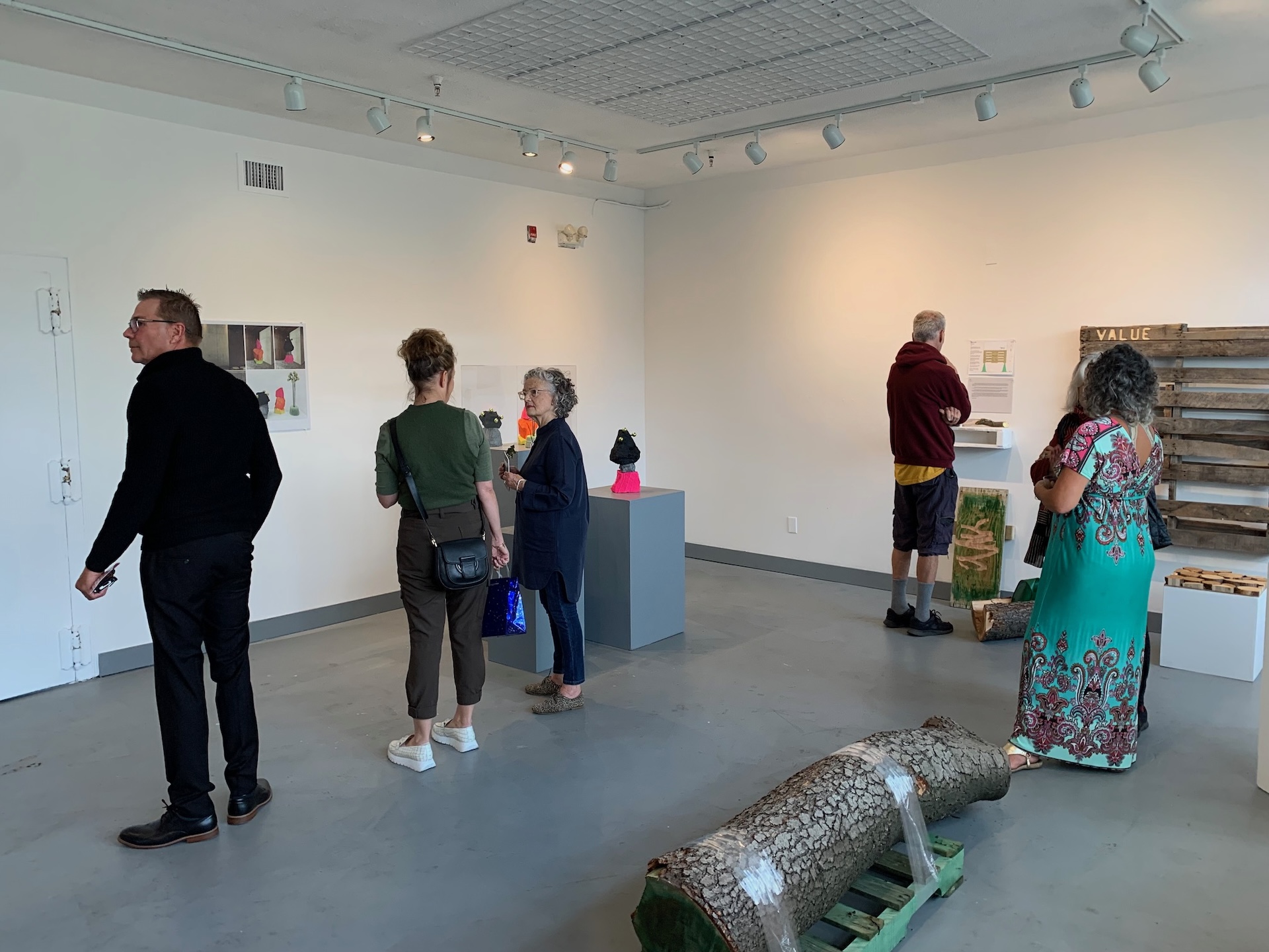 Visitors exploring a gallery exhibit of sustainable artwork as part of the RECLAIM Residency by STEPS Public Art and the Victoria Arts Council