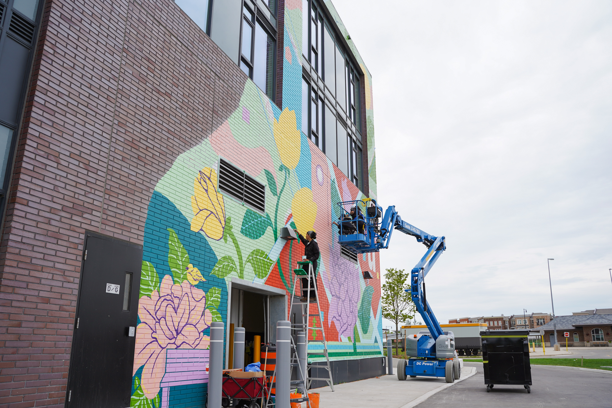 Fuelled by Coffee Collective artist team on a mural production site as part of a project with STEPS Public Art in Brampton, Ontario