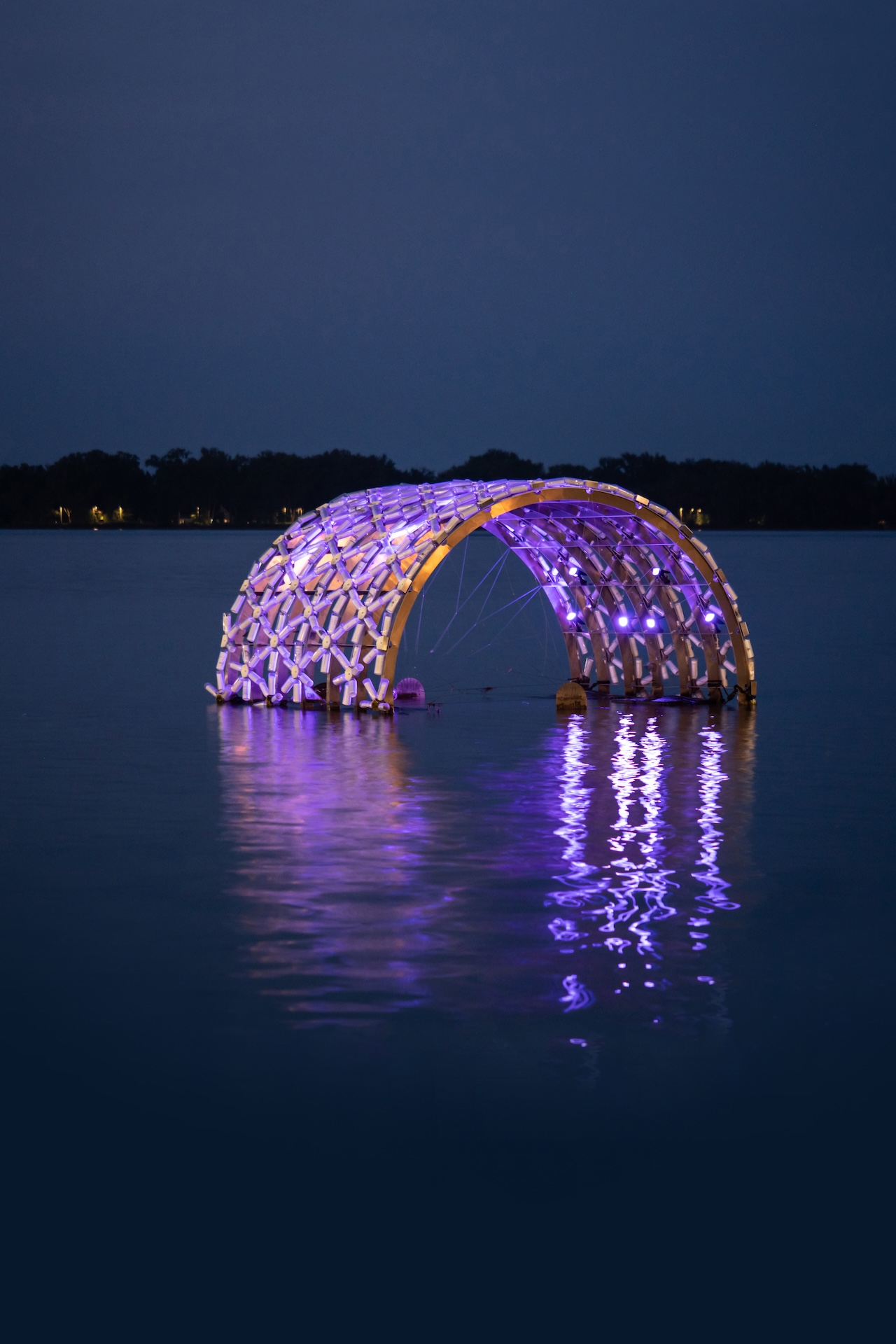 A public art installation by Javid Jah made of plastic water bottles float in Lake Ontario along Toronto's waterfront in the night.